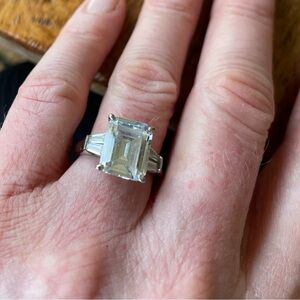Three-stone emerald-cut created white sapphire ring.